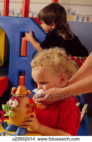 Picture -  baby child cold babies sickley ill illness wipe. Fotosearch
