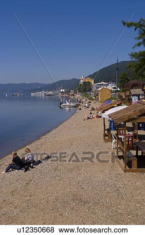 Stock Photo -  beach people beautiful relaxed shore boats . Fotosearch