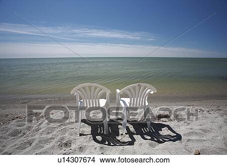 Picture -  beach water art lawn chairs lake winnipeg shore. Fotosearch