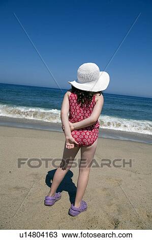 Stock Image -  beach water summer girl young looks out ocean . Fotosearch