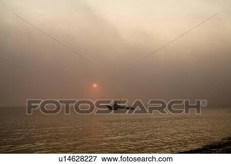 beach water sun boat sits in cape cod bay foggy View Large Photo Image Stock Photo - beach water sun boat sits in cape cod bay foggy. Fotosearch