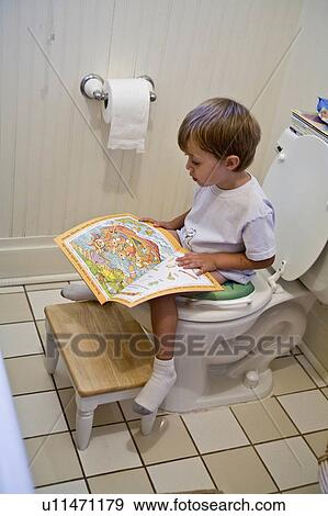 Stock Photo -  book kid young boy sits potty reading magazine. Fotosearch