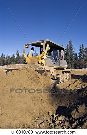 construction large bull dozer pushes mound earth View Large Photo Image Stock Image - construction large bull dozer pushes mound earth. Fotosearch