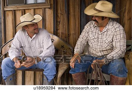 Picture -  cowboy life in usa west cowboys relax talk old. Fotosearch