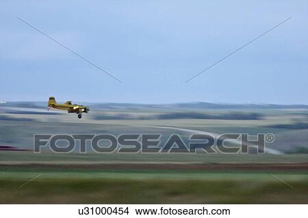 crop spraying aircraft in airplane dusting View Large Photo Image Picture - crop spraying aircraft in airplane dusting. Fotosearch