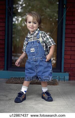 Stock Photo -  dance kid happy young boy dressed in overalls. Fotosearch