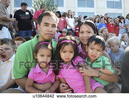 Stock Image -  family triplets sisters brother siblings parents. Fotosearch