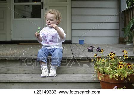 Stock Image -  flowers summer girl child young sitting porch. Fotosearch