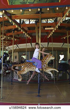 Picture -  girl child kid carousel denver zoo colorado usa. Fotosearch