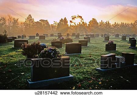 Stock Image -  god rays grave markers in cemetery canadas east. Fotosearch