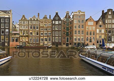 Stock Photo -  holland amsterdam canal frontal buildings boat. Fotosearch