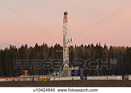 Stock Photography -  horozontal image land based drill rig sunrise. Fotosearch