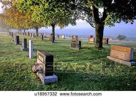 Stock Image -  leaf early morning mist beautiful rural cemetery. Fotosearch