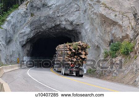log truck traveling through tunnel cut mountain View Large Photo Image Stock Photography - log truck traveling through tunnel cut mountain. Fotosearch