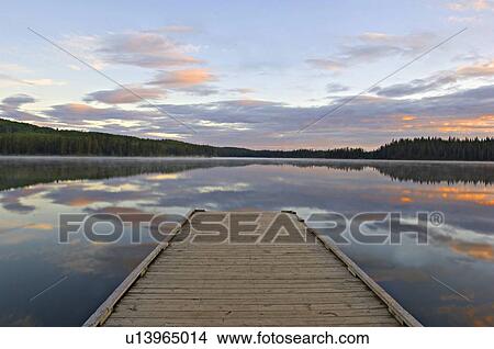 Picture -  morning sunrise boat dock jarvis lake in william. Fotosearch