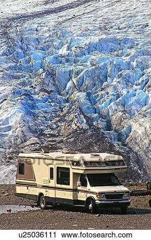Stock Image -  motorhome sits parked foot blue ice glacier . Fotosearch