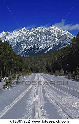 Stock Image -  nature winter snow covered road in leading ridge. Fotosearch