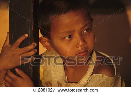 Stock Photo -  nepal chitwan national park young boy in village. Fotosearch