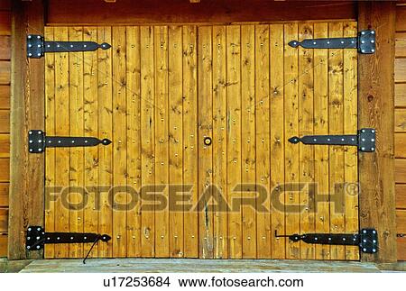 Picture -  pair closed heavy wooden barn doors huge black. Fotosearch