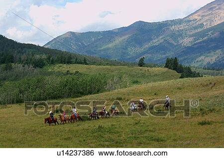 people group trail ride through scenic landscape View Large Photo Image Stock Photograph - people group trail ride through scenic landscape. Fotosearch