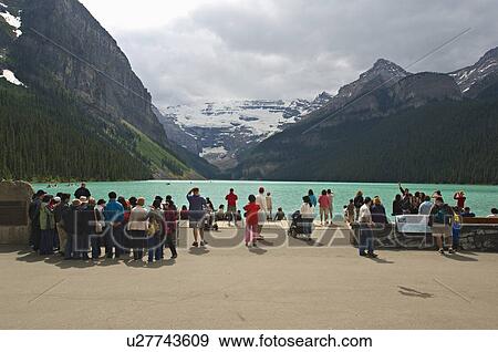 Stock Photo -  people tourist boardwalk lake louise in banff. Fotosearch