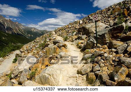 Stock Photo -  person smooth upward path through rocks winding. Fotosearch