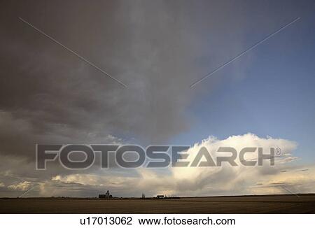 Stock Image -  scenic view prairies grain elevator clouds field. Fotosearch