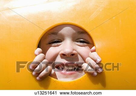 summer smiling young boy peeks through opening View Large Photo Image Stock Image - summer smiling young boy peeks through opening. Fotosearch