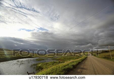 summer storm clouds in slough pothole roadside View Large Photo Image Stock Photo - summer storm clouds in slough pothole roadside. Fotosearch
