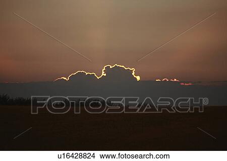 Picture -  sun art sunlit cloud sunset sundown setting. Fotosearch