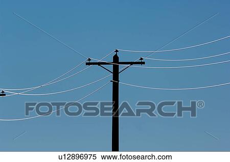 Stock Photography -  sun power pole electric cables backlit rising. Fotosearch