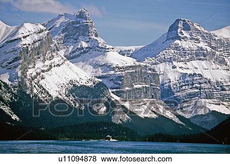 Stock Photo -  tour boat winds its way snow capped rocky. Fotosearch