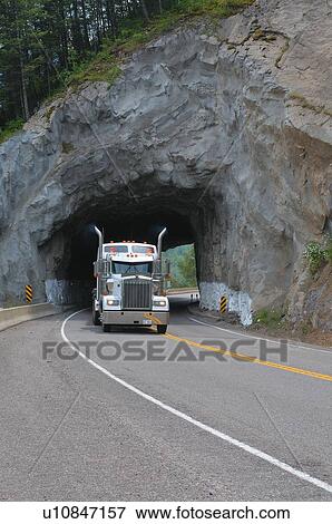 Stock Photo -  truck passing through rock tunnel highway 3 . Fotosearch