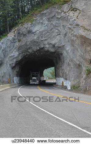 Stock Image -  truck passing through rock tunnell highway 3 . Fotosearch