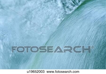 Stock Image -  water flowing over waterfall fresh powerful pure. Fotosearch