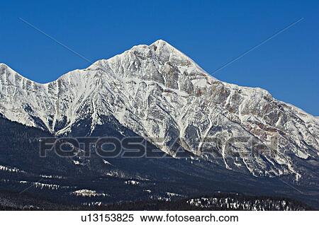 Stock Photography -  winter image snowcapped pyramid mountain clear. Fotosearch