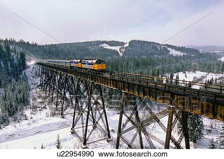 Stock Image -  winter via rail passenger train crossing steel. Fotosearch