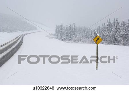 winter yellow caution highway sign unplowed two View Large Photo Image Stock Photo - winter yellow caution highway sign unplowed two. Fotosearch