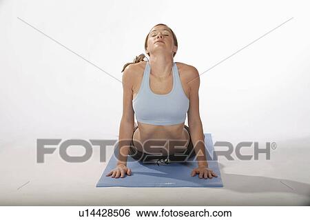 Stock Photograph -  woman beautiful sexy young practices yoga mat. Fotosearch
