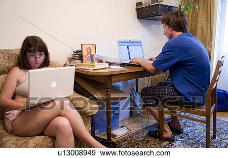 Stock Photo - woman computer man internet modern mac pc in living room ukraine kiev. Fotosearch
