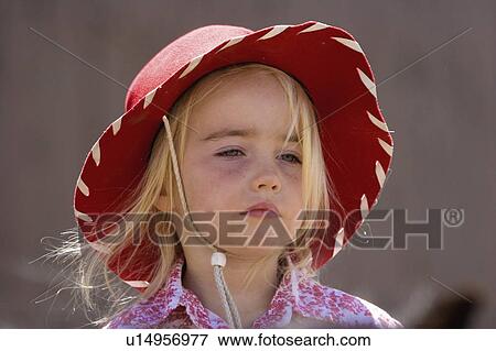 Stock Photo -  woman horse young cowgirl sits atop ranch in res. Fotosearch