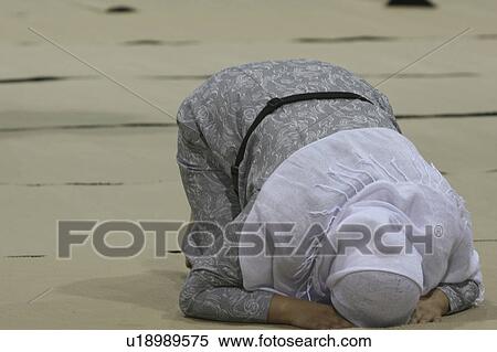 Stock Photography -  woman love face female praying kneeling down awe. Fotosearch