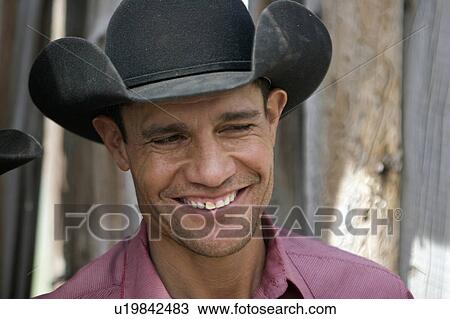 Stock Image -  working cowboy ranch in colorado wearing hat. Fotosearch