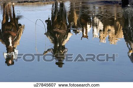 Stock Photo -  working cowboys cowgirls reflected in river. Fotosearch