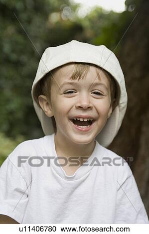 young boy wearing white tshirt cap smiling View Large Photo Image Stock Image - young boy wearing white tshirt cap smiling . Fotosearch