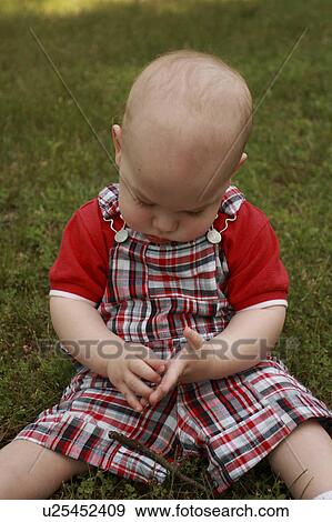 Stock Photo -  baby nature boy childhood discover learn play. Fotosearch