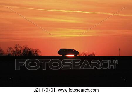 Stock Image -  car silhouette iowa clouds freedom highway sky. Fotosearch