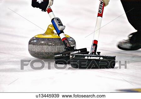 close up curling rock sweeping brooms 2 stones View Large Photo Image Stock Photo - close up curling rock sweeping brooms 2 stones. Fotosearch