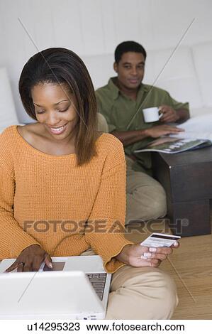 Stock Image -  computer people couple home laptop african thier. Fotosearch