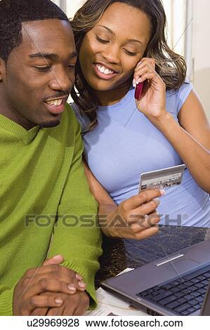 Stock Photo -  computer people couple internet laptop buying. Fotosearch